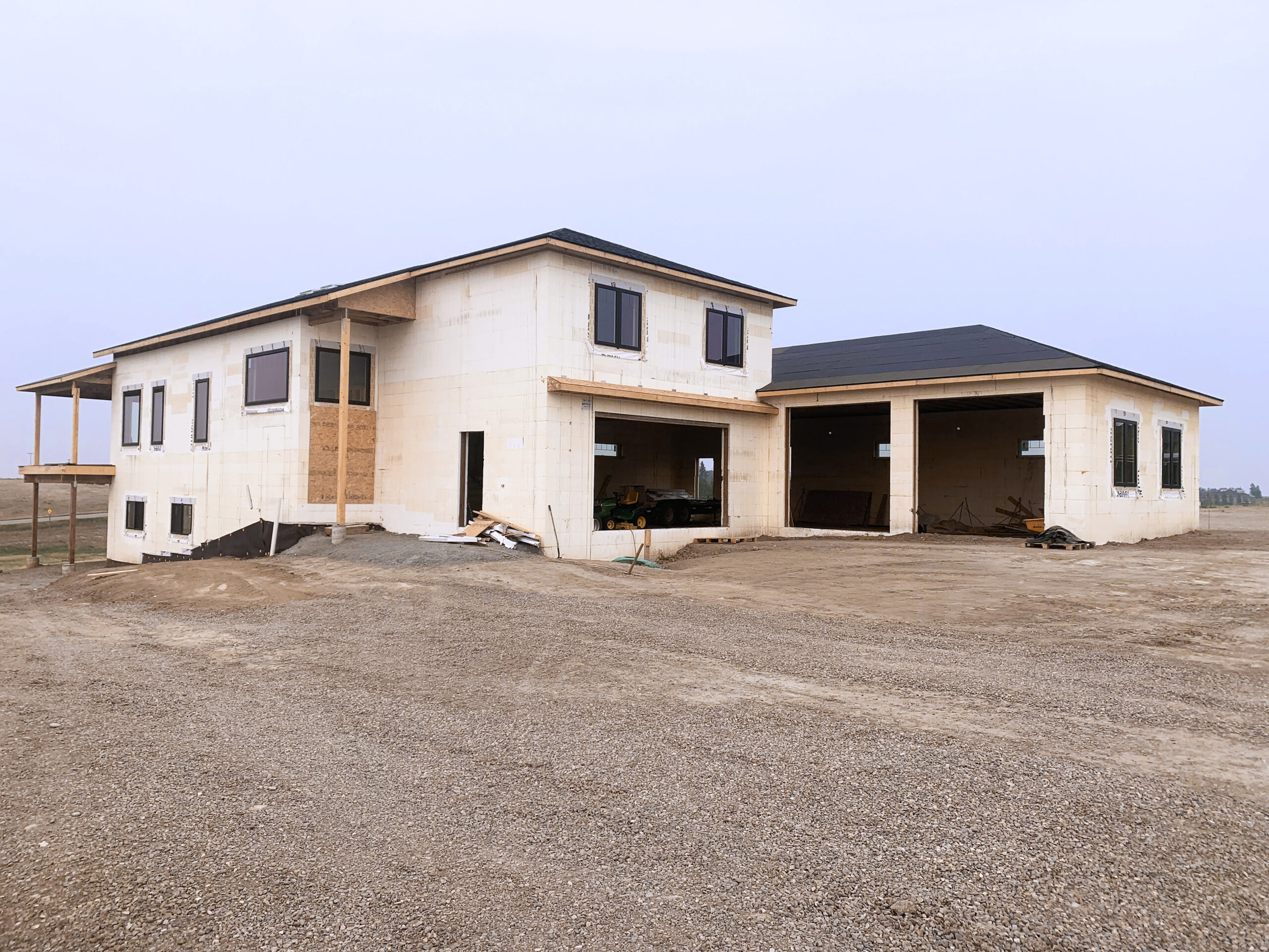 This image depicts a two-story home being built with ICF blocks.
