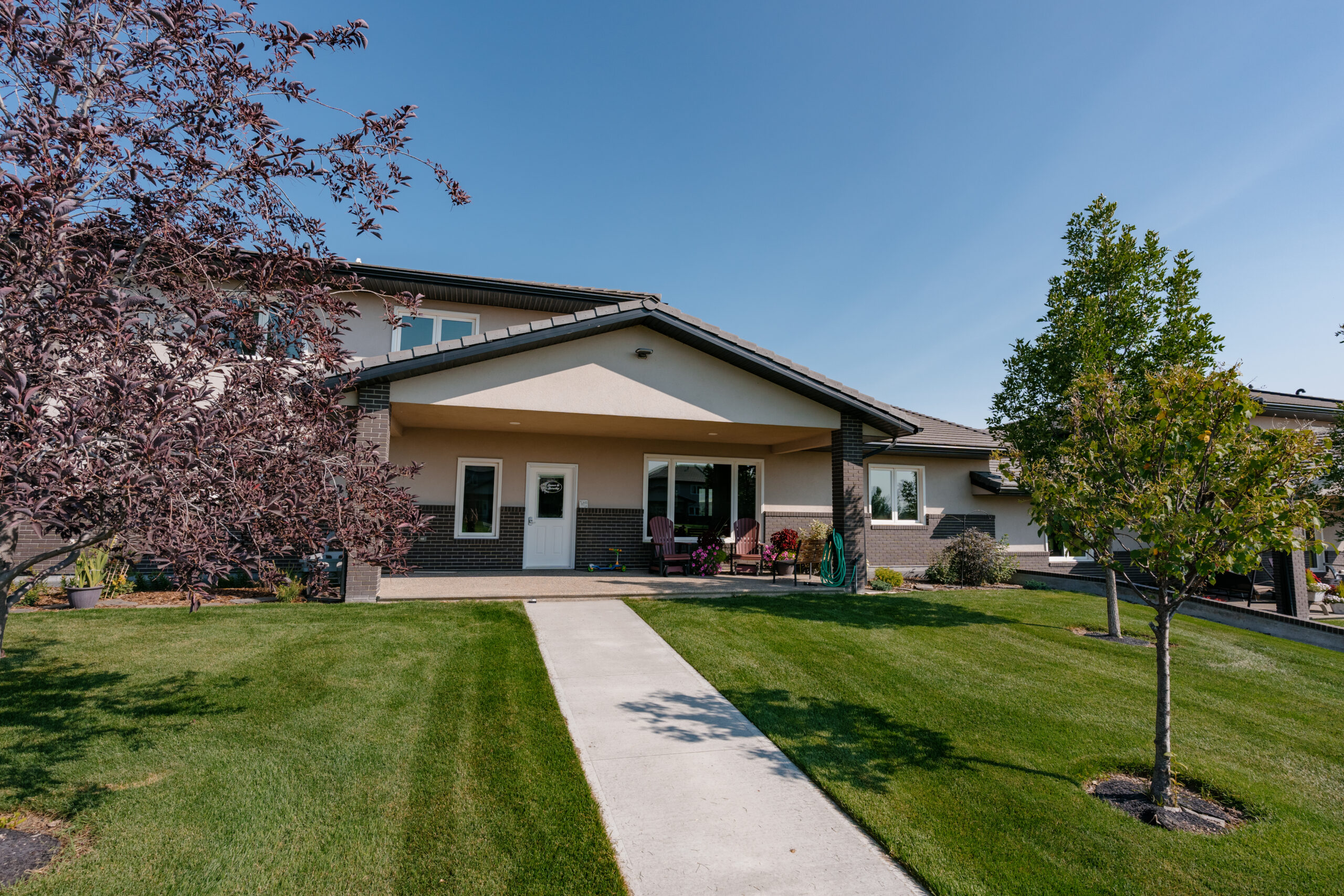 This image depicts a finished two-story ICF home on a sunny day.