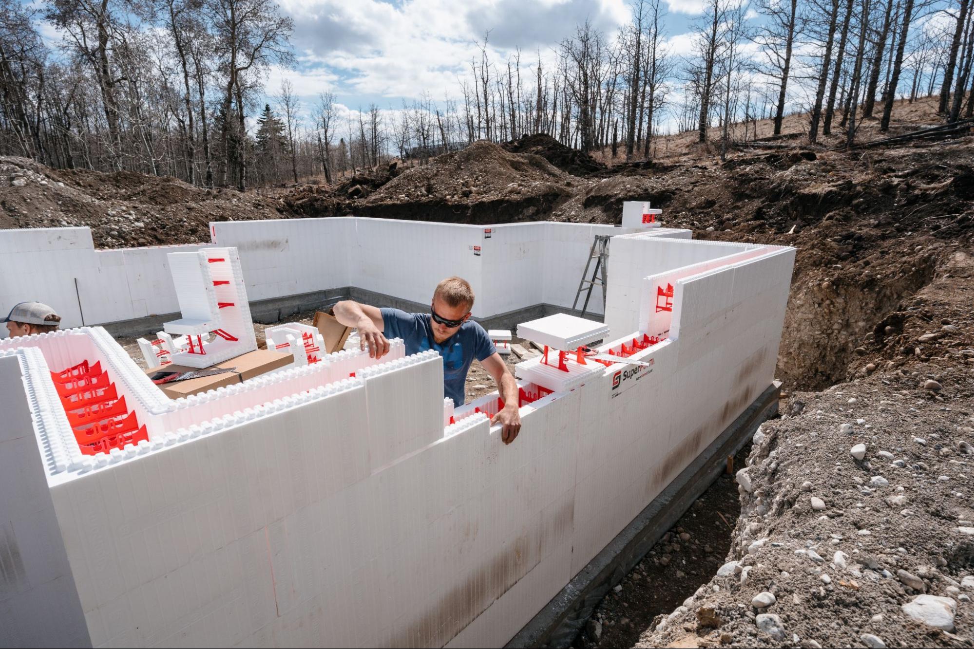 A professional is installing SuperForm ICF blocks on a job site.