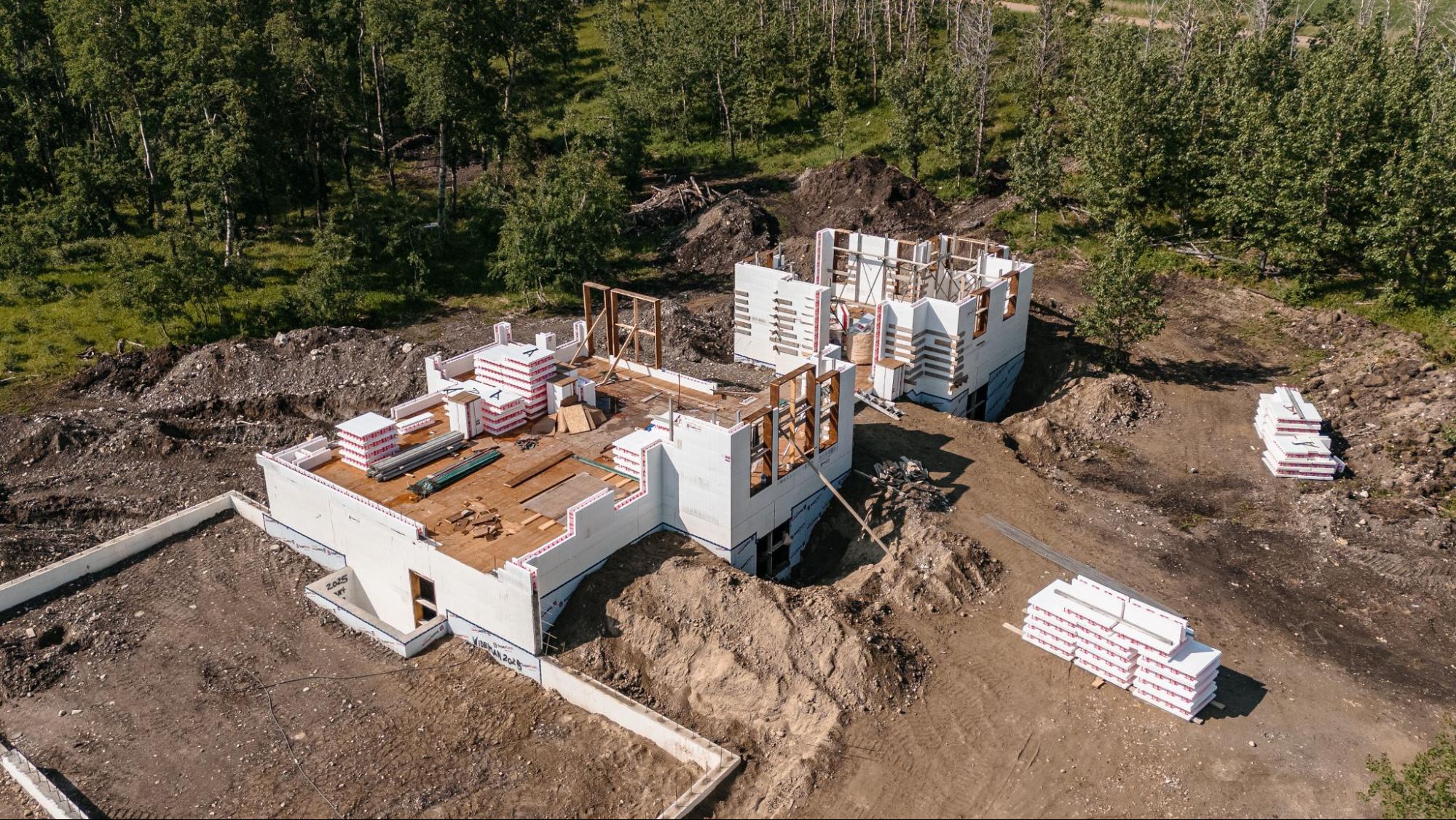 Two structures featuring SuperForm ICF walls are in the middle of construction.